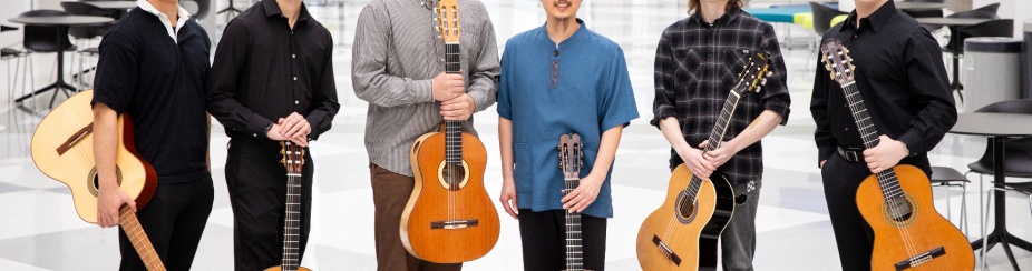 Six guitar players pose in the artirum of the Center for the Arts. 