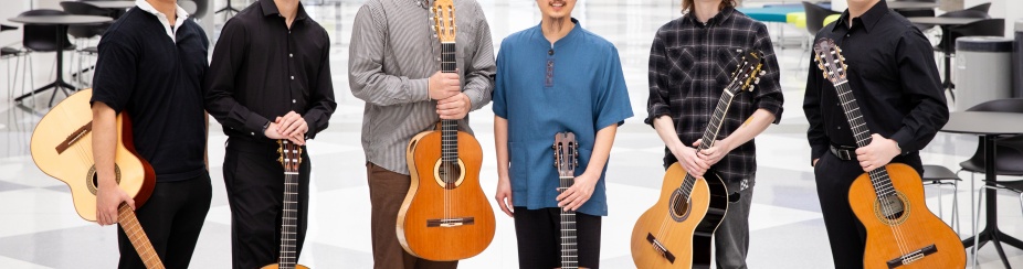 Six guitar players pose in the artirum of the Center for the Arts. 