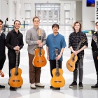 Six guitar players pose in the artirum of the Center for the Arts. 