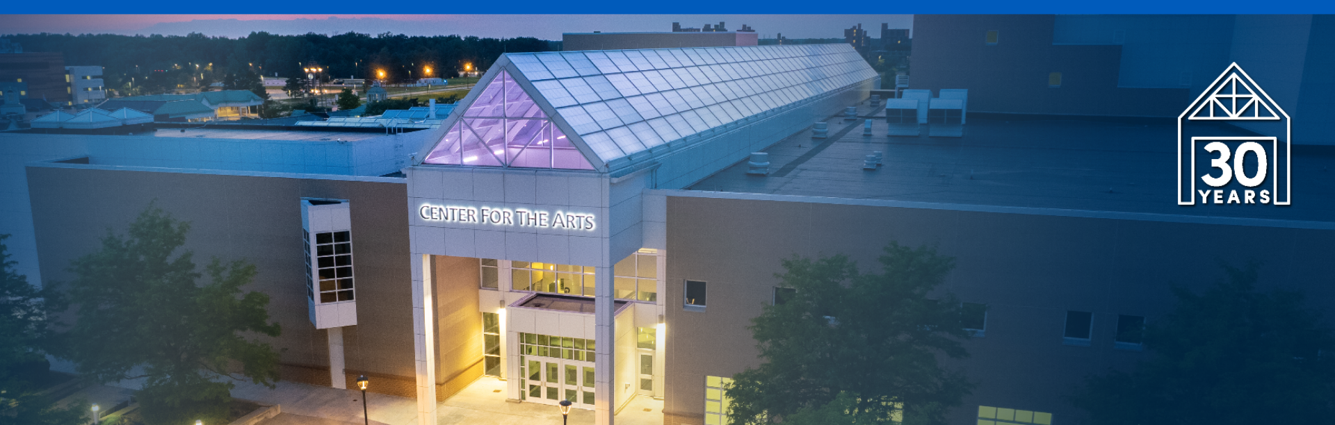 arial view of center for the arts entrance at night.