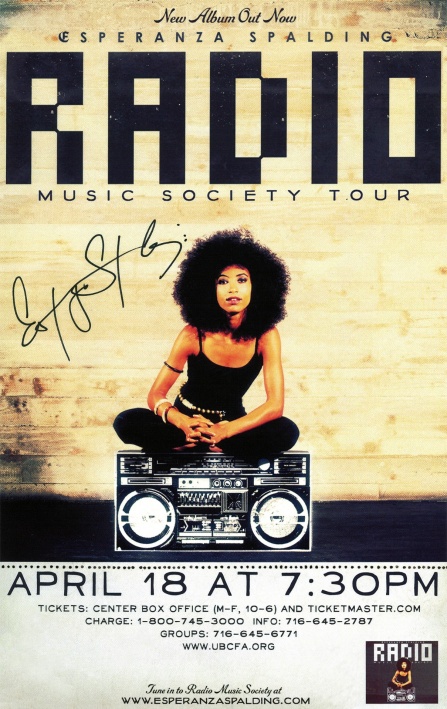 esperanza spalding sitting cross legged on a boombox.