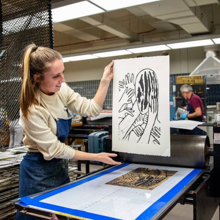 student screen printing in an art lab.