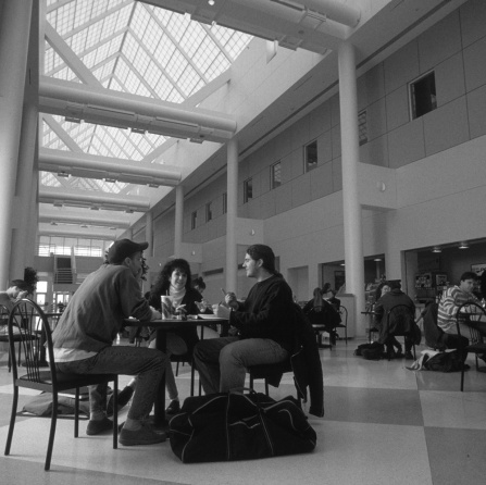 students sitting at tables in the cfa atrium.