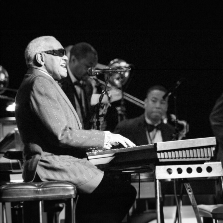 ray charles performing on the piano.