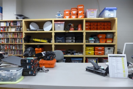 Counter with shelves of art equipment for rental. 