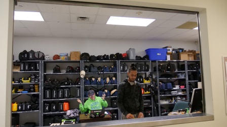 students behind counter with media equipment. 