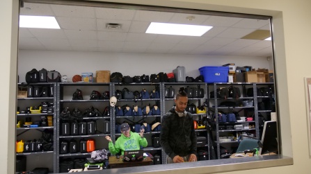 students behind counter with media equipment. 