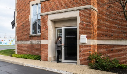 brick building and glass doors of UB Anderson Gallery. 