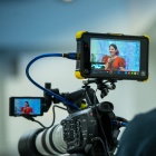 person looking through back of video camera screen. 