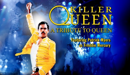 Patrick Myers of Killer Queen dressed as Freddie Mercury with fist raised in the air. 