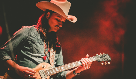 duanne betts wearing a cowboy hat playing electric guitar. 