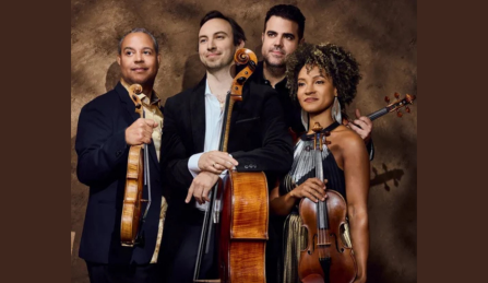 Members of Harlem Quartet posing with instruments. 