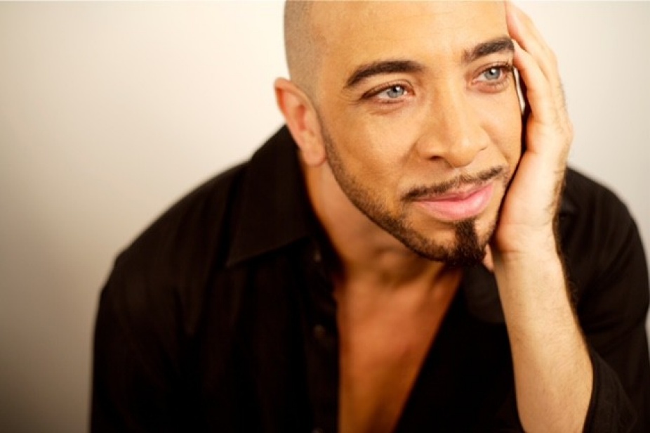 Dwight Rhoden posing with hand on side of face. 