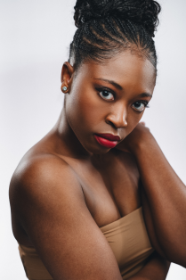 Imani Sailers posing with hand on neck. 