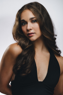 marissa mattingly posing with hair on shoulder. 