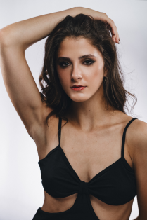 lucy stewart posing with arm above head. 