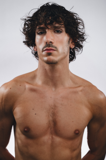 vincenzo di primo posing without a shirt on. 