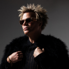 Brian Culbertson wearing glasses and a dark fur coat. 