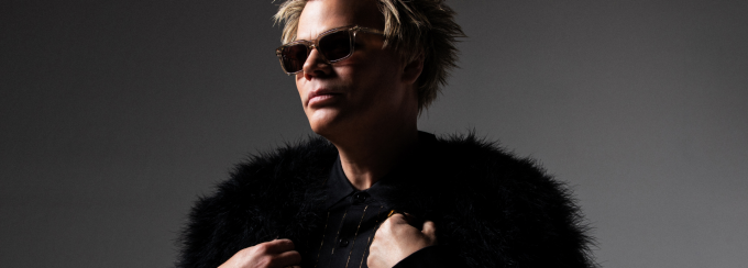 Brian Culbertson wearing glasses and a dark fur coat. 