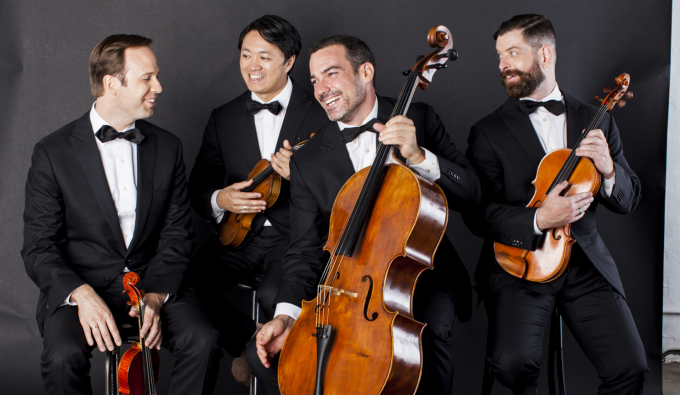 miro quartet members posing with instruments and smiling. 