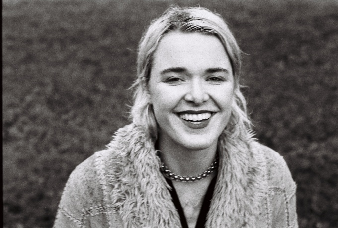 portrait of brennan wedl smiling wearing a fur coat.