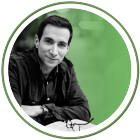 black and white portrait of andrew ross sorkin posing in front of an open book. 