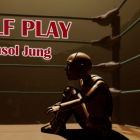 A wooden puppet sitting in the corner of a boxing ring. 