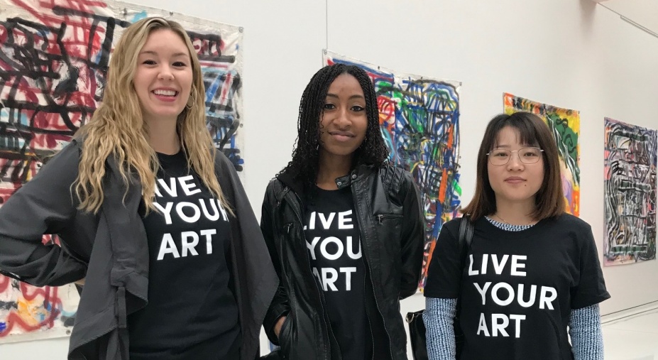 Three female students wearing Live Your Art t-shirts.